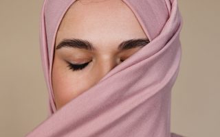 woman covering her face with pink hijab