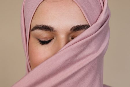 woman covering her face with pink hijab