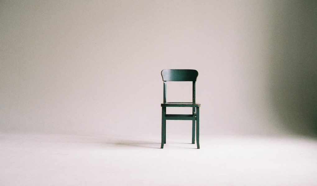 wooden chair on a white wall studio